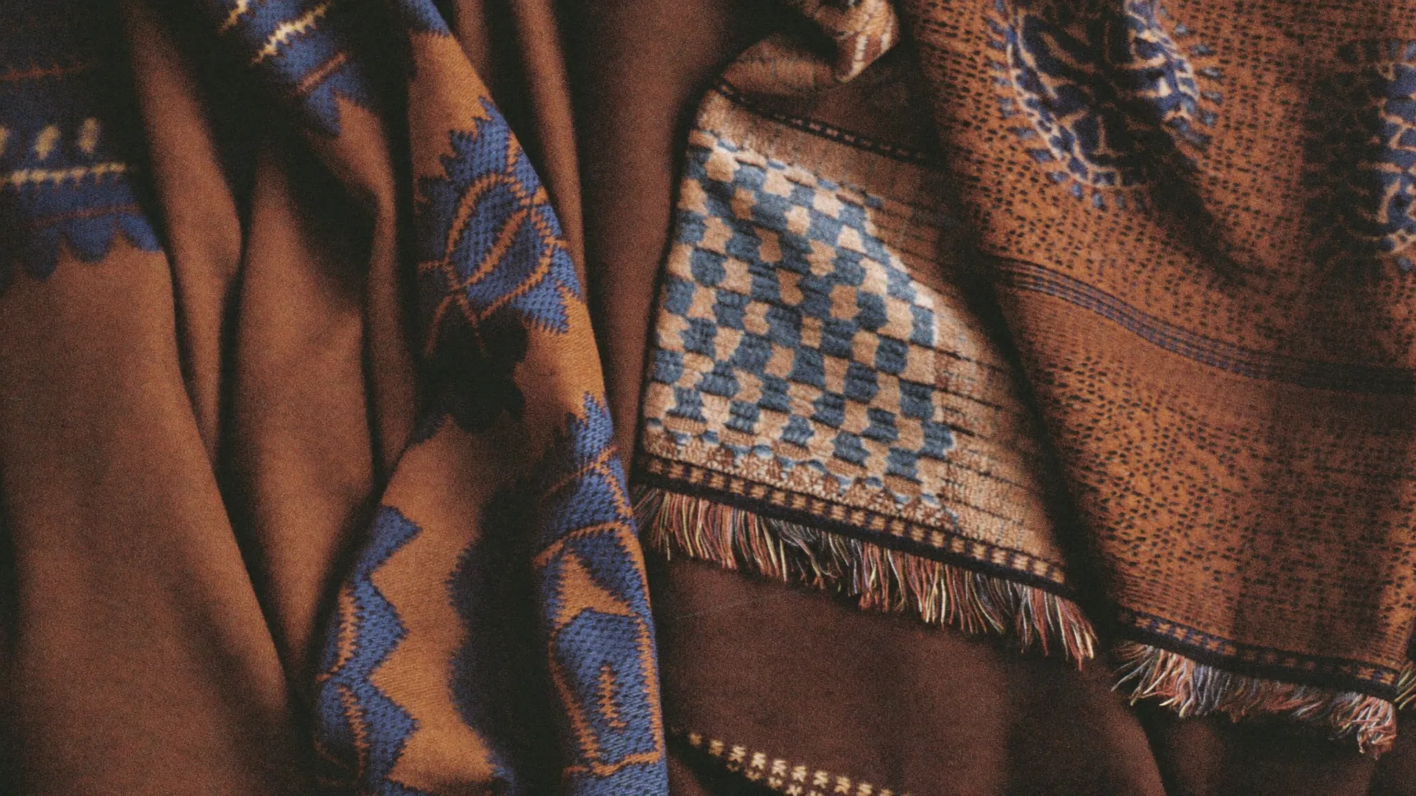 Layered handwoven Javanese batik and lurik textiles in brown and gold
