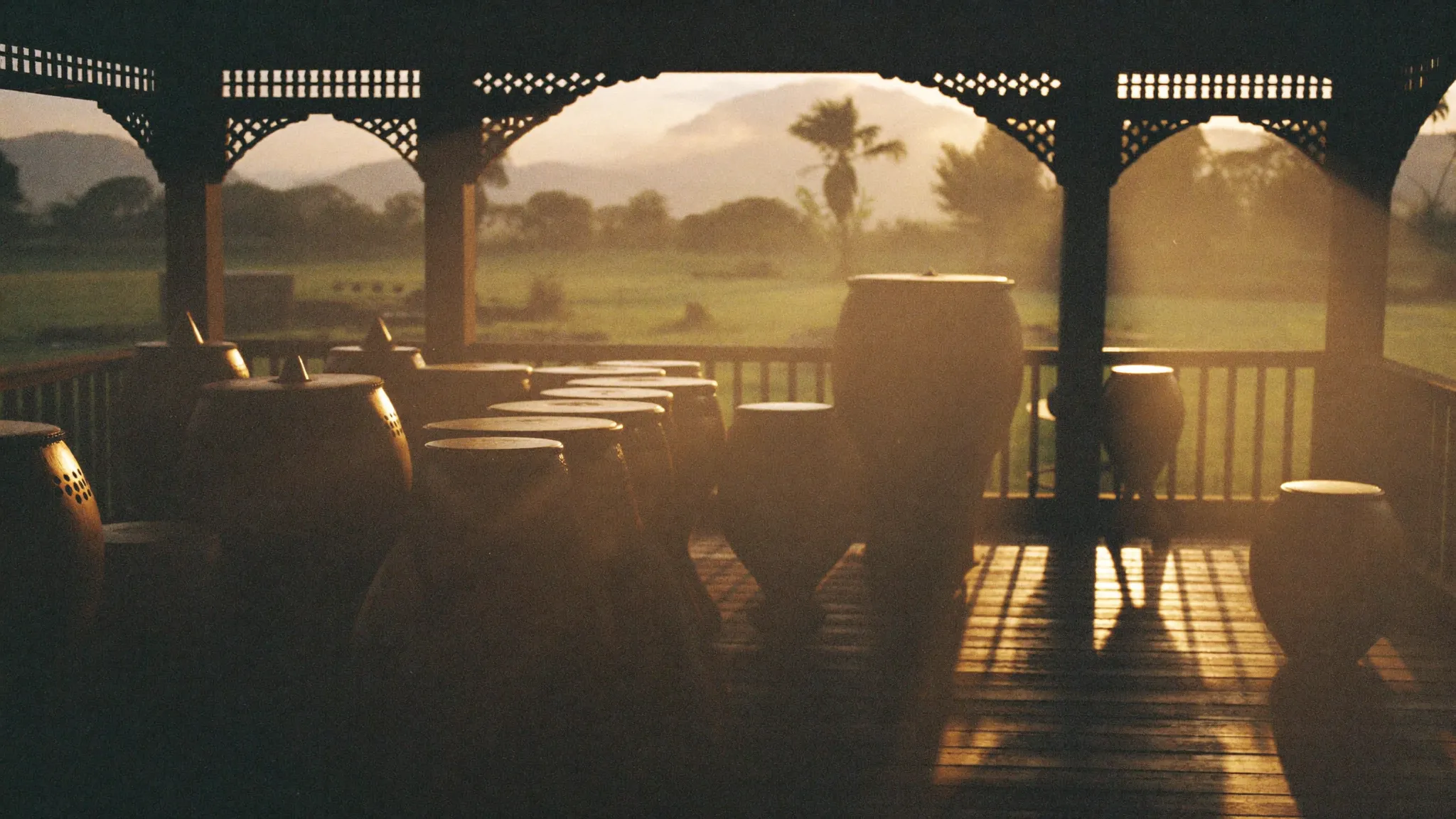 Bronze gamelan keys catching morning light in a pavilion